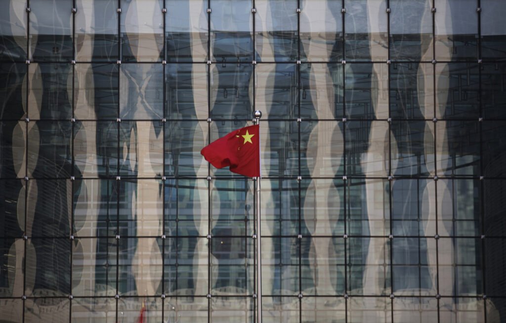 chinese-national-flag-flutters-at-the-headquarters-of-a-commercial-bank-on-a-financial-street-near-the-headquarters-of-the-people-s-bank-of-china-china-s-central-bank-in-central-beijing_rsz