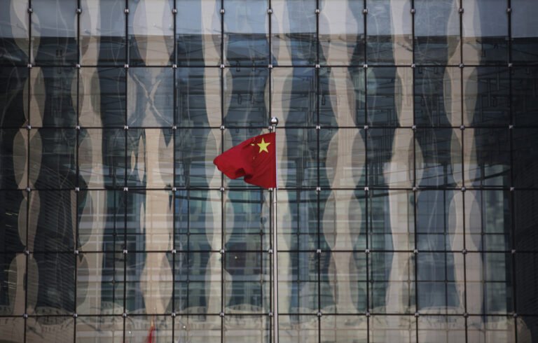 chinese-national-flag-flutters-at-the-headquarters-of-a-commercial-bank-on-a-financial-street-near-the-headquarters-of-the-people-s-bank-of-china-china-s-central-bank-in-central-beijing_rsz